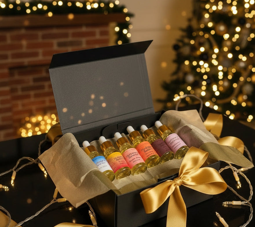 Set of small bottles of Hydrate & Balance body oil with colorful labels in a black box