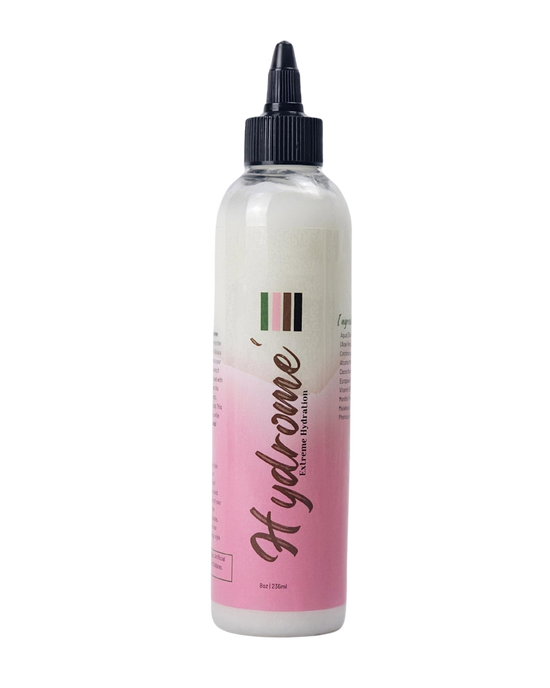 Clear bottle with black twist top filled with creamy conditioner.