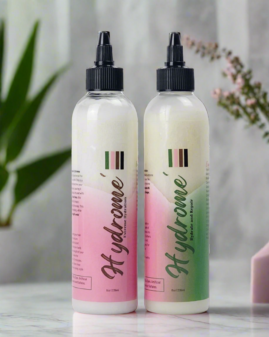 2 clear product bottles with black top full of white creamy conditioner.