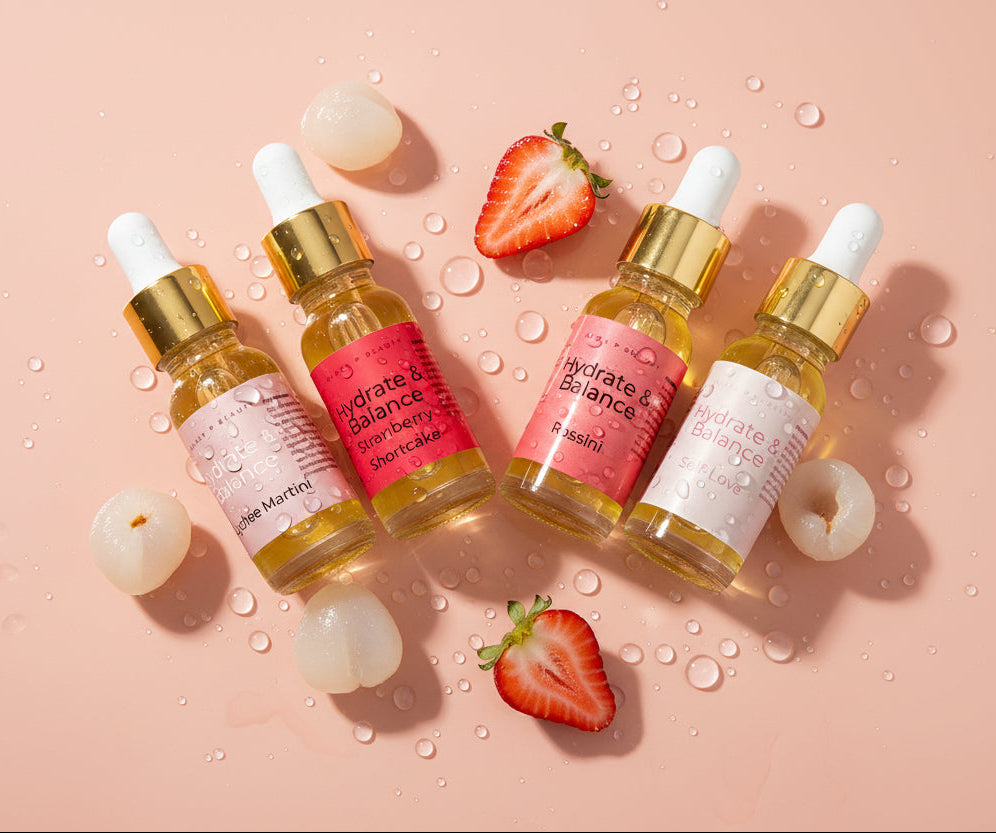Four dropper bottles with pink labels on a white background